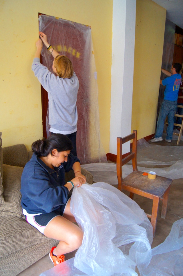 GROW interns Brony Long and Anum Lalani helping to cover things that didn't need painting with plastic. 